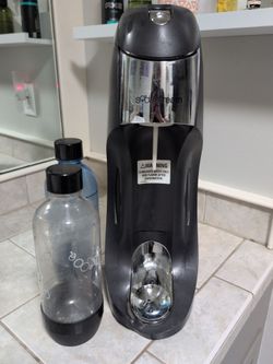Sodastream brand soda maker, two bottles