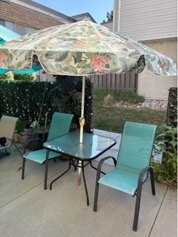 Table chairs and umbrella