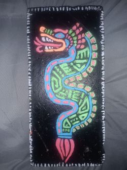 A stylized representation of an Aztec or Mayan-inspired serpent/dragon motif.