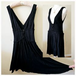 Size M Free People Black Tank Fit and Flare Sleeveless Rayon Dress with Open V Neck Front and Button Design Belly. 100% Rayon.

Measures 14" (28") Pit