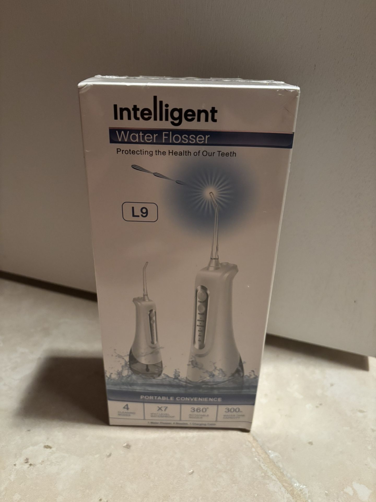 Brand New in sealed package not opened portable Water Flosser.4 cleaning modes. 4 nozzles included