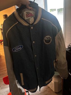 vintage JH Design denim racing jacket features embroidered 40th Anniversary Ford Mustang logos on the back and shoulders.