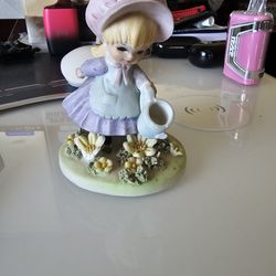 Porcelain Figurine Of Girl Watering Flowers