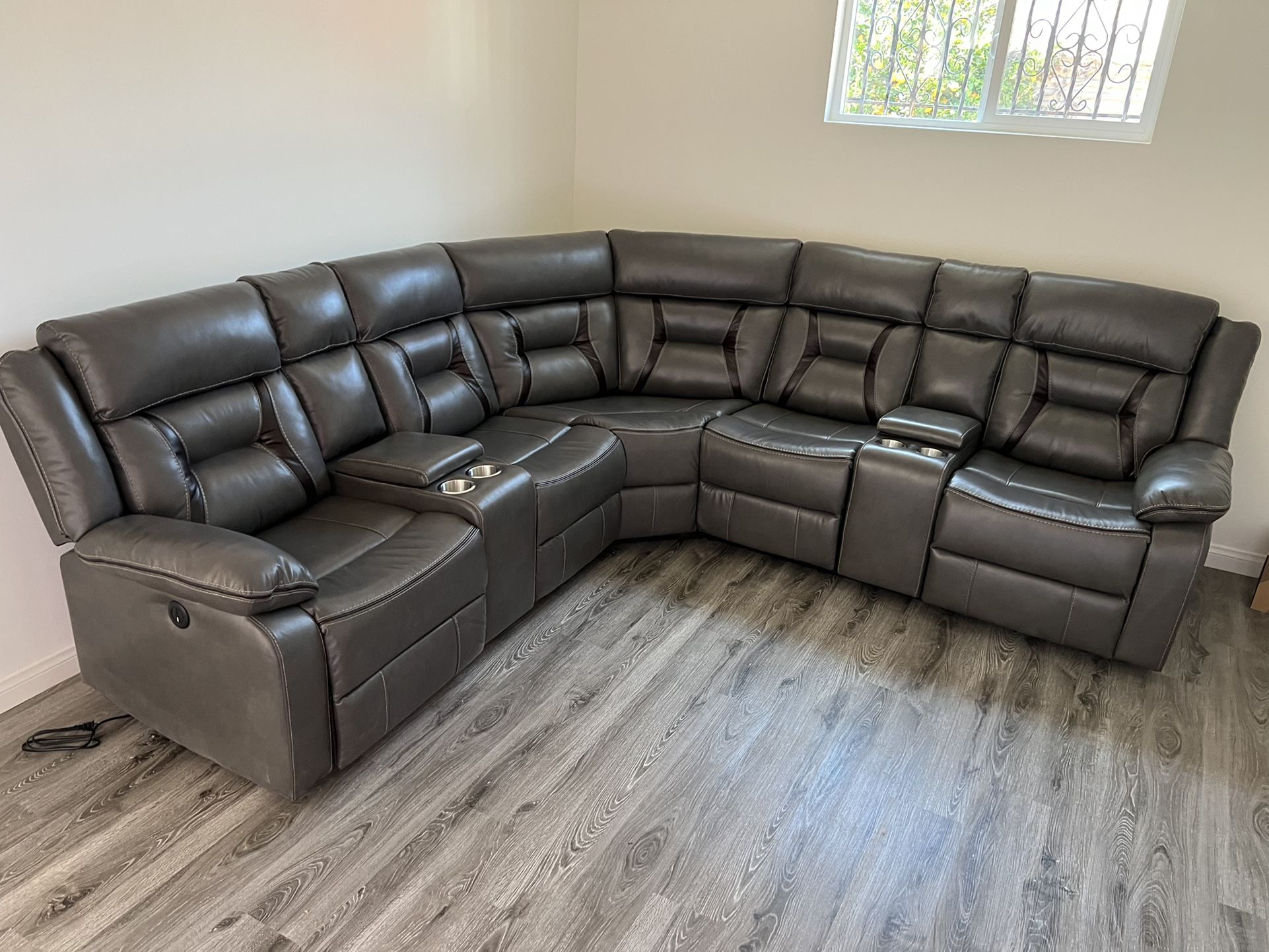 New Reclining Sectional . Grey Gel Leatherette . 106” X 106”. Free Delivery !