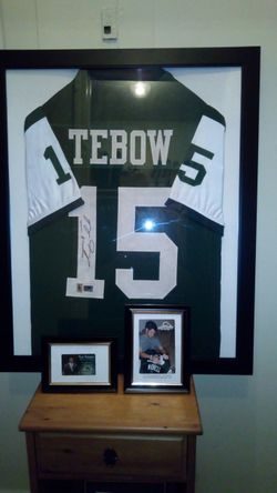 Authentic hand sighed Tim tebow custom framed Jersey with certificate of authenticity and picture of signing