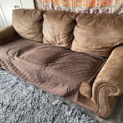 Comfy brown sofa with cover