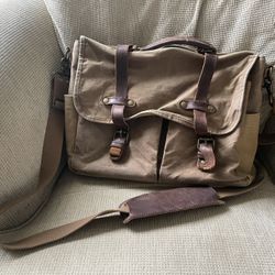 Brown canvas messenger bag with leather straps.