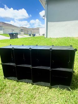 Black modular organizer with 8 cubes, measuring 49” x 26” x 12”.