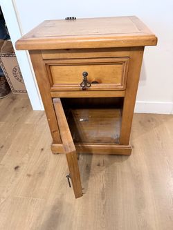 Oak nightstand with iron decor