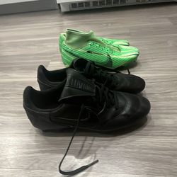 2 pairs of cleats black pair is a 6.5 green pair is 5.5