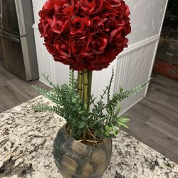 Red rose topiary ball in decorative vase