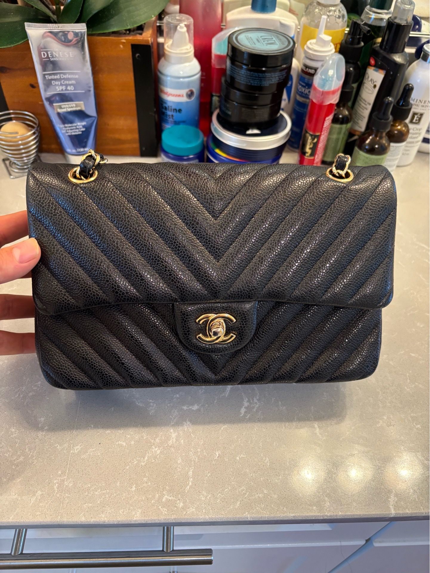 Chanel Classic Flap Chevron Quilted Caviar Leather Medium Double Flap Bag in black with gold-tone hardware.