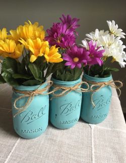 Distressed mason jar vases with silk flowers