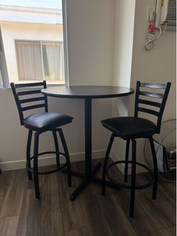 Black bar stools and table