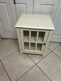 Ivory wood and glass-paneled accent cabinet or chairside chest,