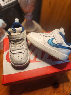 Nikes white with blue paw print