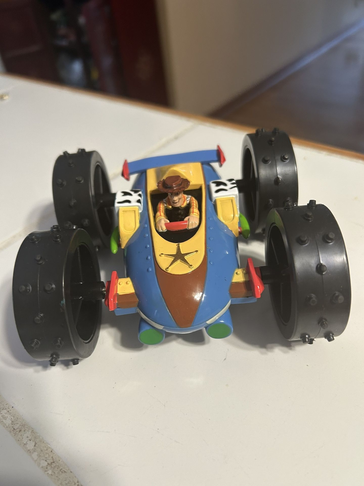 The item is a Disney Pixar Toy Story RC buggy toy featuring Woody. It is an authentically licensed radio control car from the Toy Story movies. The