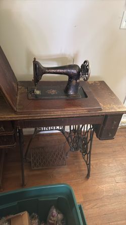 Singer treadle sewing machine with wooden cabinet