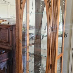 Tall lion curio display cabinet.