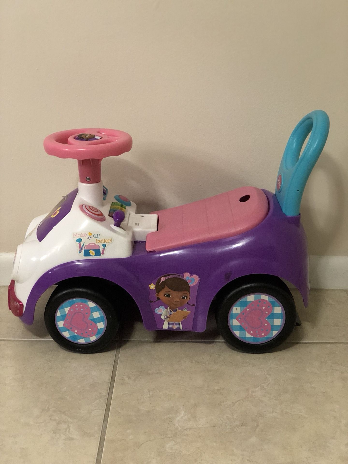 Doc Mcstuffins pink and purple ride on toy car