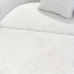 Light grey round sofa with storage