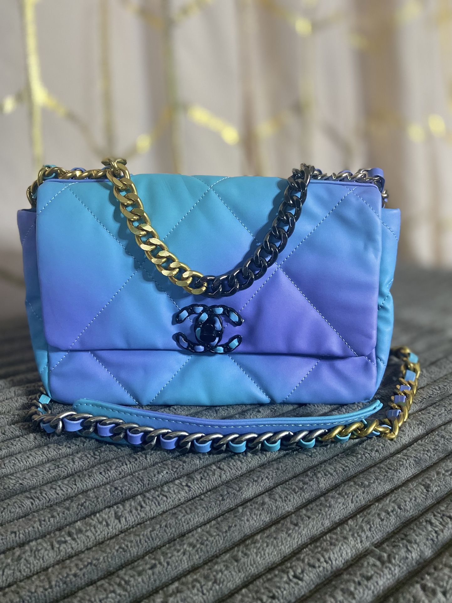 Blue And Purple Purse With A Leather Chain Strap