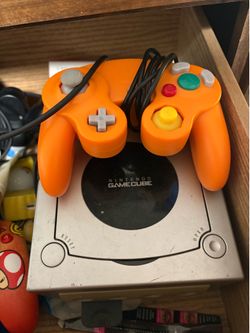 Nintendo GameCube with orange controller and Call Of Duty Finest Hour
