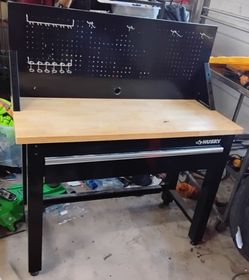 Husky 48 in. W x 20 in. D 1-Drawer Black Workbench with Pegboard and Solid Wood Top.  In great condition.