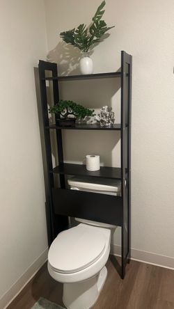 Black Over-the-Toilet Storage Shelf with decorative vase