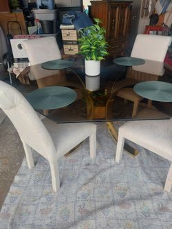 Glass top table with 4 white chairs good condition