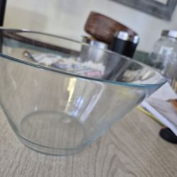 a glass salad bowl with hand made wooden fork and spoon 