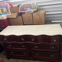Dark brown dresser with white marble top mirror with chandelier holders