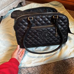 Vanderpump black quilted pet carrier bag.