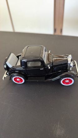 This is a National Motor Museum Mint 1:32 scale diecast model of a 1932 Ford 3-Window Coupe in black with red wheels.