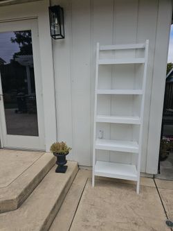Crate and Barrell white leaning bookshelf