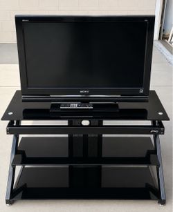 Sony TV with its stand and TV controller