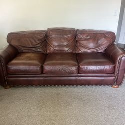 1 Brown leather couch  and 2 Brown leather chairs with ottoman