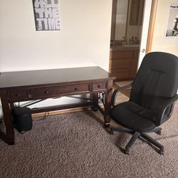 Brown desk and black chair 