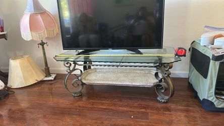 Glass top 50" L by 30" wide coffee table . 18" high .