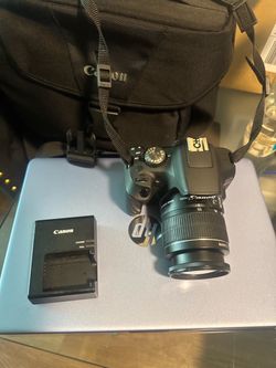Canon T7 Rebel camera, battery charger and case.