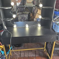 Black vanity with mirror and lights
