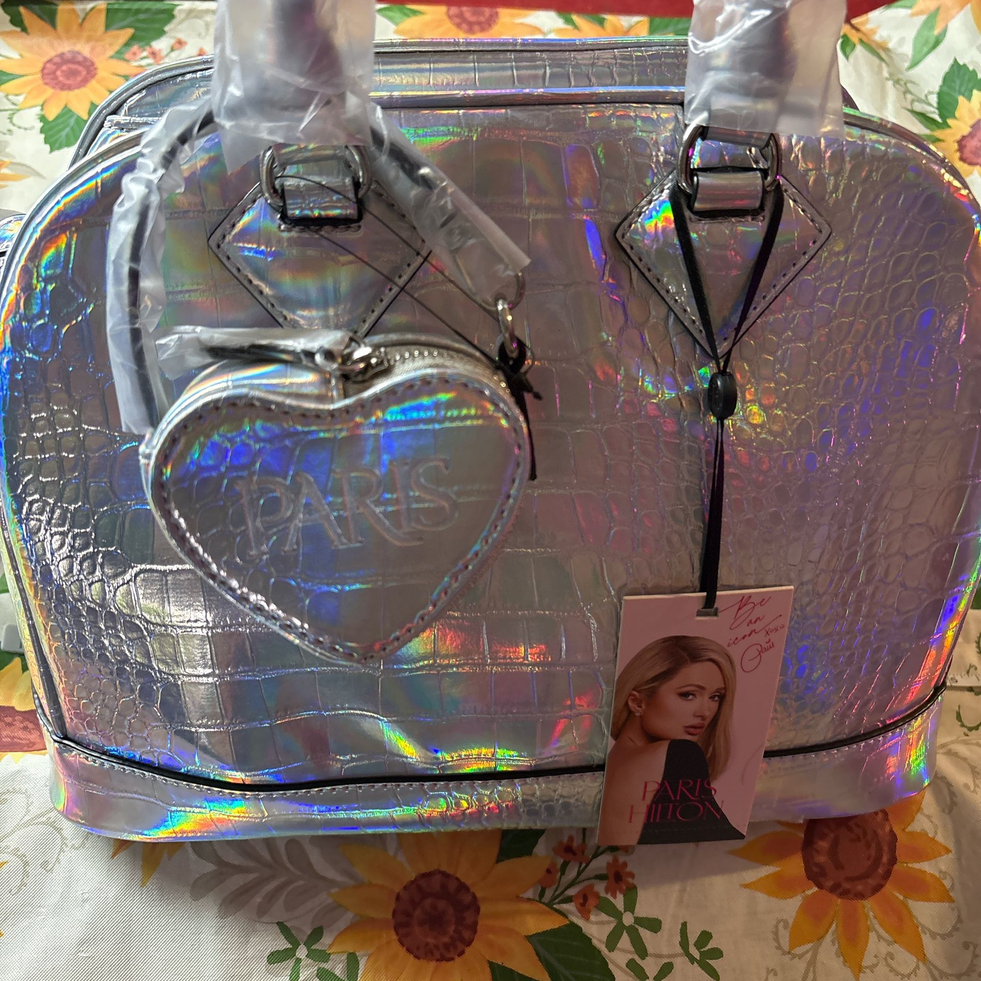 Silver holographic Paris Hilton bag with heart charm #holographic