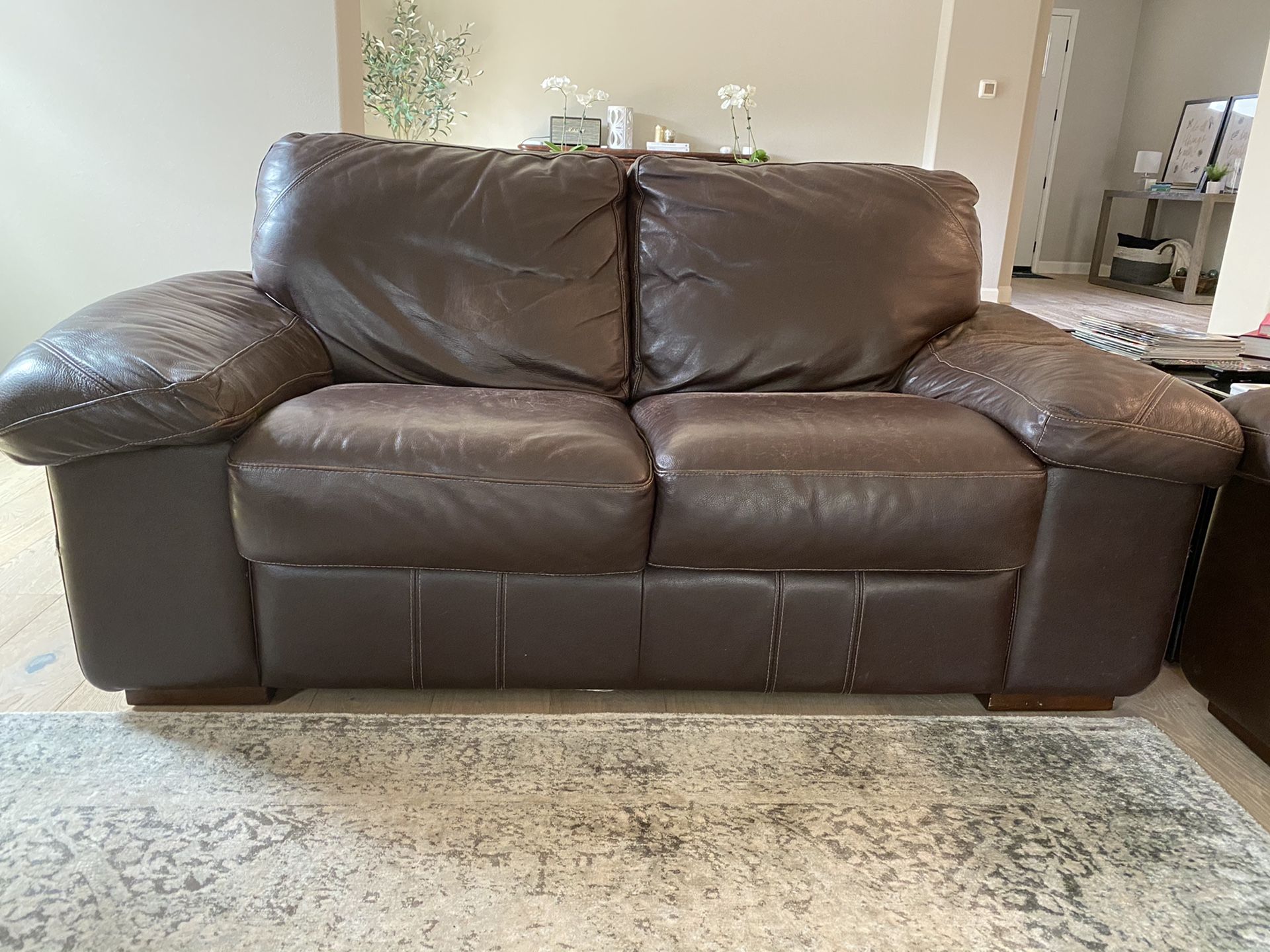 Espresso leather loveseat and ottoman