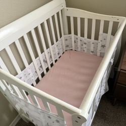Crib with mattress. Includes: mattress cover and sheets ( girl or boy) I have both