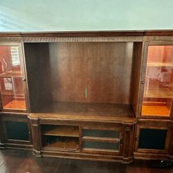 Brown Wooden Entertainment Center With Glass Shelves And Lights