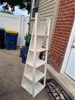 A beautiful, white floor mirror with 5 shelves (63” tall x 18” long x 16” wide in the bottom) the top one is (4” wide) just different