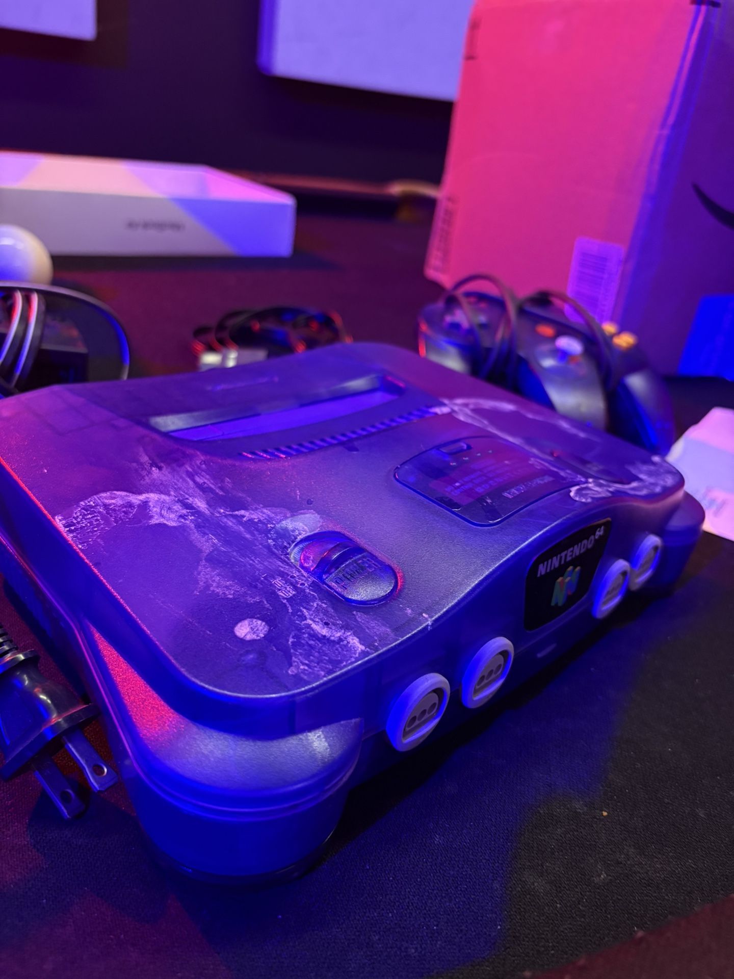 Purple Nintendo 64 with wires and controller