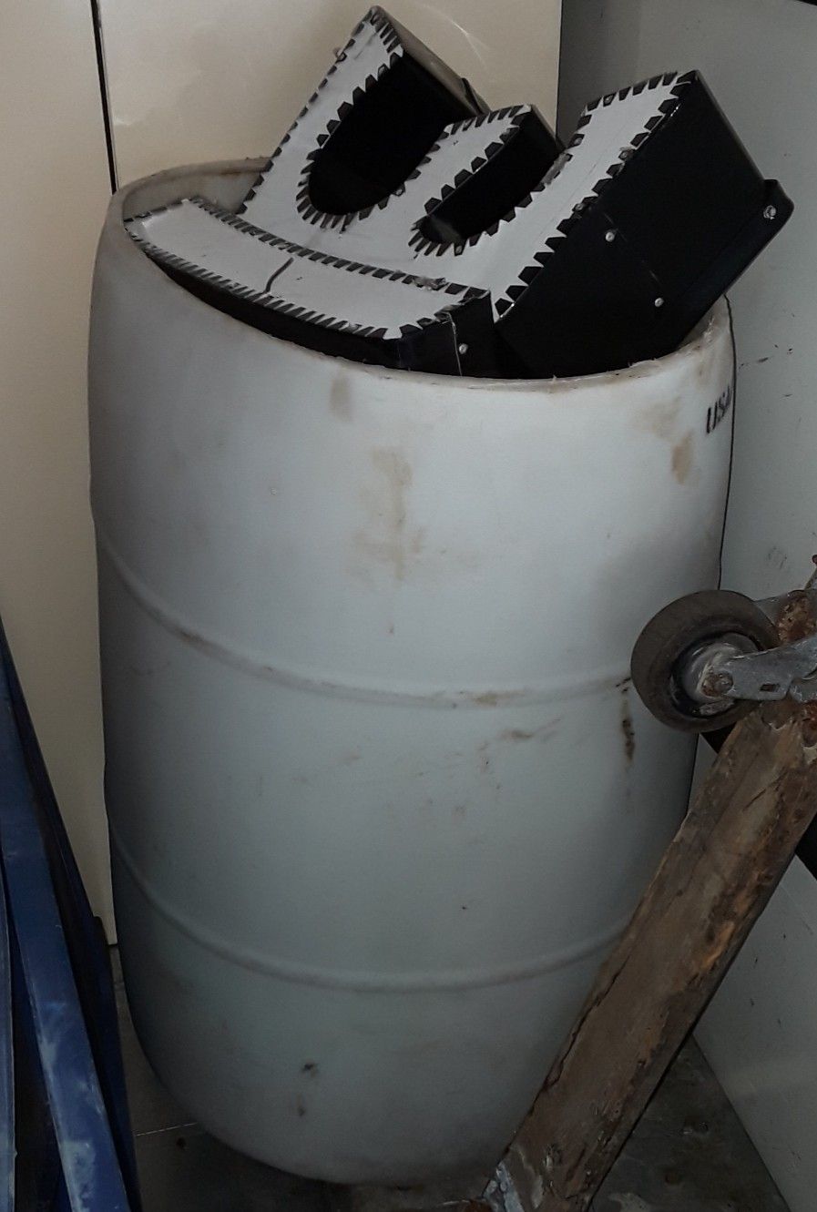White translucent 55 gallon plastic barrel with open top