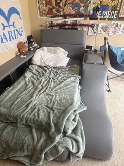 Grey twin bed with storage on side