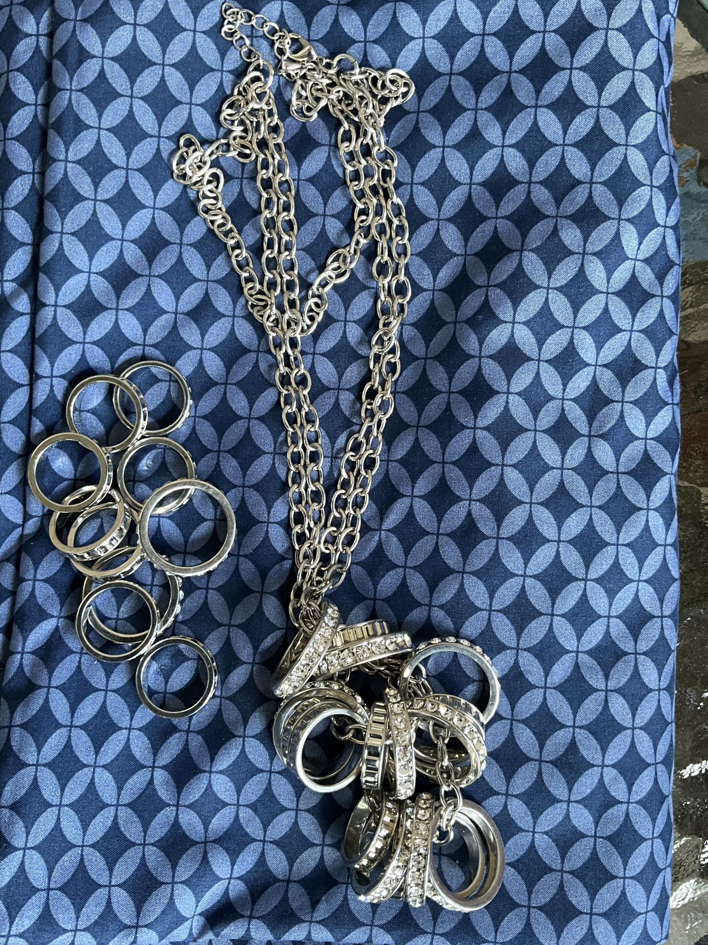 An elegant necklace with rings and rhinestones, and a set of 10 rings